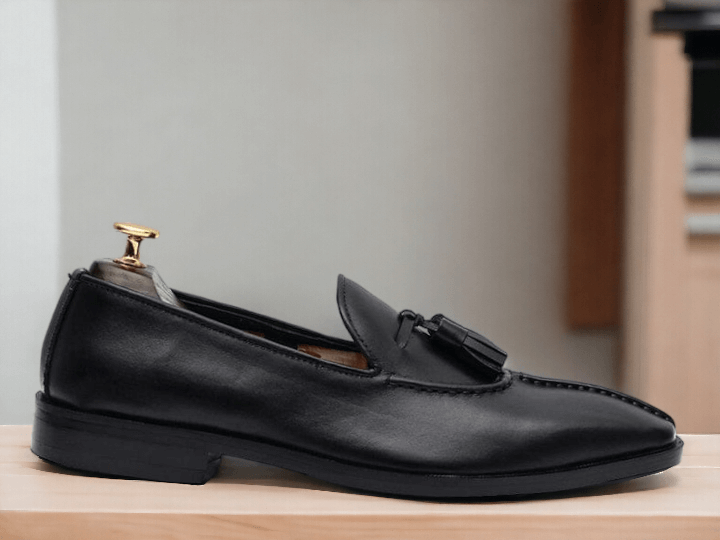 Handmade with premium black leather, these men's loafer dress shoes are the epitome of style and comfort. The meticulously crafted design ensures a perfect fit for any occasion. Experience the luxury and sophistication of these handmade shoes. Don't settle for anything less.