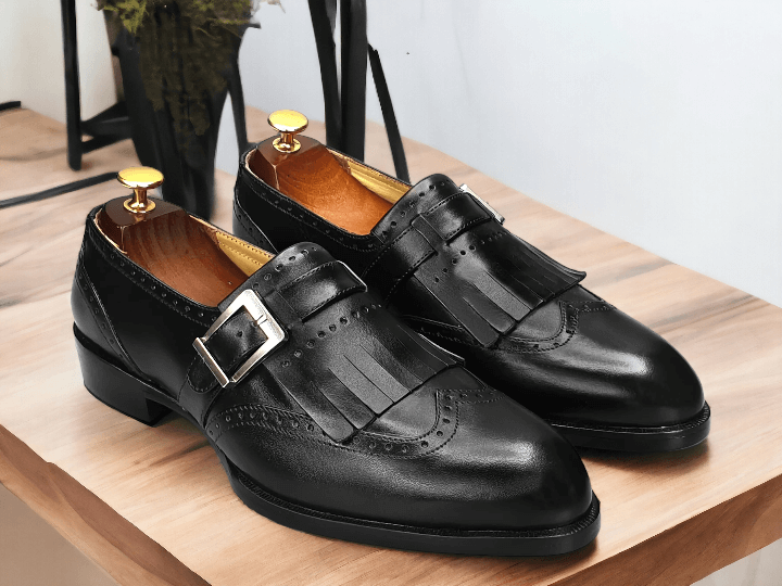 Crafted with precision and expertise, our Handmade Black Leather Monk Fringe Shoes elevate any outfit. Made with premium leather, these Men's Oxford Shoes showcase a unique monk fringe design for a touch of sophistication. Step out in style with these handcrafted shoes that offer both durability and unmatched style.