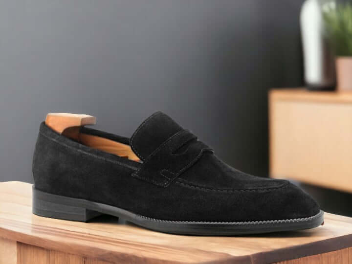 Expertly crafted from high-quality suede and featuring a subtle alligator pattern, these handmade penny loafers are the epitome of sophistication and style. The slip-on design offers effortless comfort and convenience, making them the perfect choice for any formal or casual occasion. Elevate your shoe collection with these timeless black suede penny loafers.