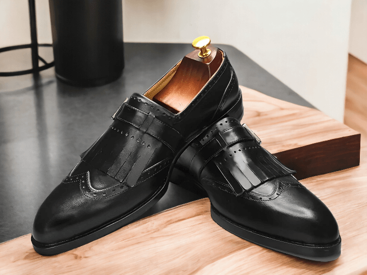 Crafted with precision and expertise, our Handmade Black Leather Monk Fringe Shoes elevate any outfit. Made with premium leather, these Men's Oxford Shoes showcase a unique monk fringe design for a touch of sophistication. Step out in style with these handcrafted shoes that offer both durability and unmatched style.