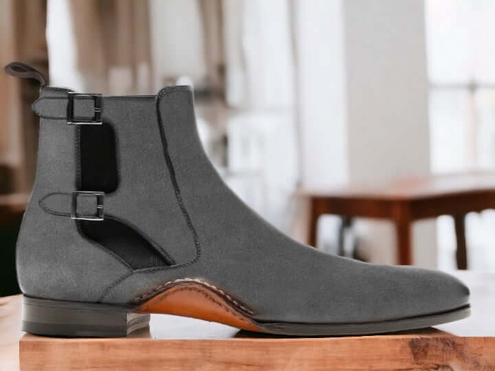 Introducing our Bespoke Buckle Chelsea Boots, featuring handmade suede and a stylish buckle design. These dress formal slip on boots are perfect for any occasion, providing both style and comfort. Step up your footwear game with our ankle-high boots for men.