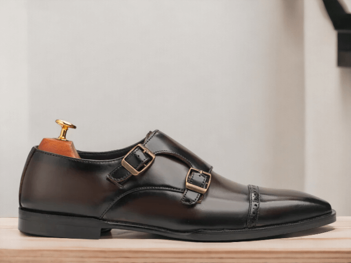 These Brown Monk Strap Shoes are the perfect combination of style and comfort. Made with high-quality black calf leather, they feature double monk straps for a sleek and sophisticated look. With sizes ranging from E to EEE, these shoes are available for every foot size. Elevate your wardrobe with these versatile and timeless shoes.