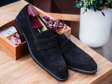 Expertly crafted from high-quality suede and featuring a subtle alligator pattern, these handmade penny loafers are the epitome of sophistication and style. The slip-on design offers effortless comfort and convenience, making them the perfect choice for any formal or casual occasion. Elevate your shoe collection with these timeless black suede penny loafers.