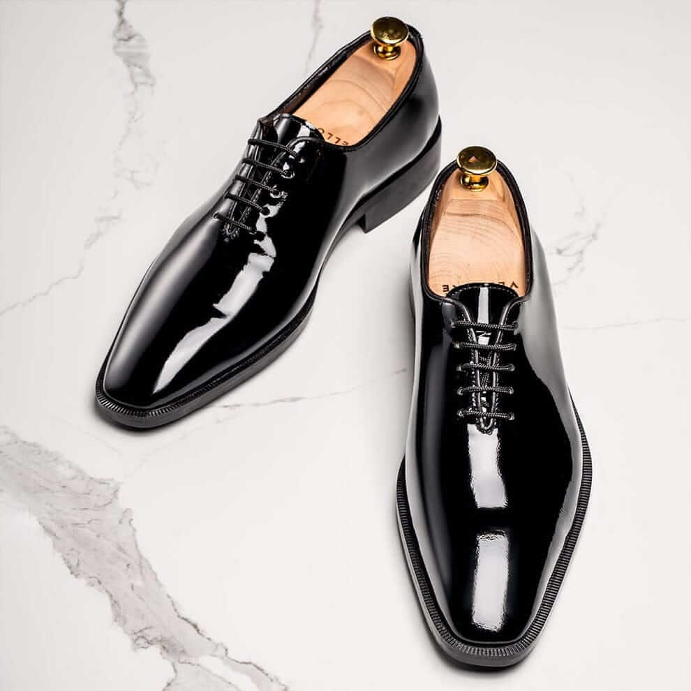 Classic Whole cut Oxford Italian dress shoes in black patent leather. A perfect complement to a Tuxedo, the whole cut Oxfords in black patent is the perfect Dress Shoes 