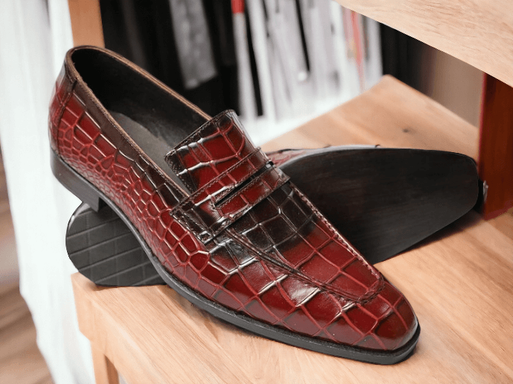 Expertly crafted and handmade, these men's red alligator print shoes offer a unique and stylish addition to any outfit. Slip on design for easy wear. The alligator print adds a touch of sophistication. Perfect for any occasion.