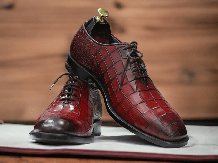 These Purple Alligator Print Leather Oxfords Shoes combine sturdy Italian leather with a classic oxford style for an exquisite look. The alligator print adds a unique style to the classic design, making these shoes the perfect choice for any occasion.