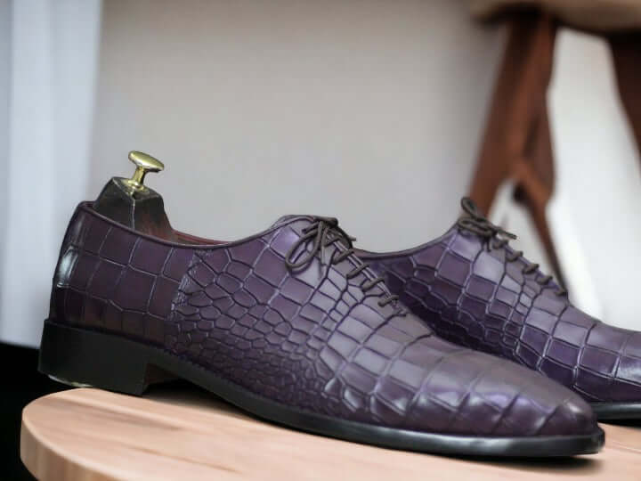 These Purple Alligator Print Leather Oxfords Shoes combine sturdy Italian leather with a classic oxford style for an exquisite look. The alligator print adds a unique style to the classic design, making these shoes the perfect choice for any occasion.