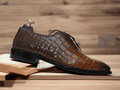 These Brown Alligator Print Leather Oxfords Shoes combine sturdy Italian leather with a classic oxford style for an exquisite look. The alligator print adds a unique style to the classic design, making these shoes the perfect choice for any occasion.