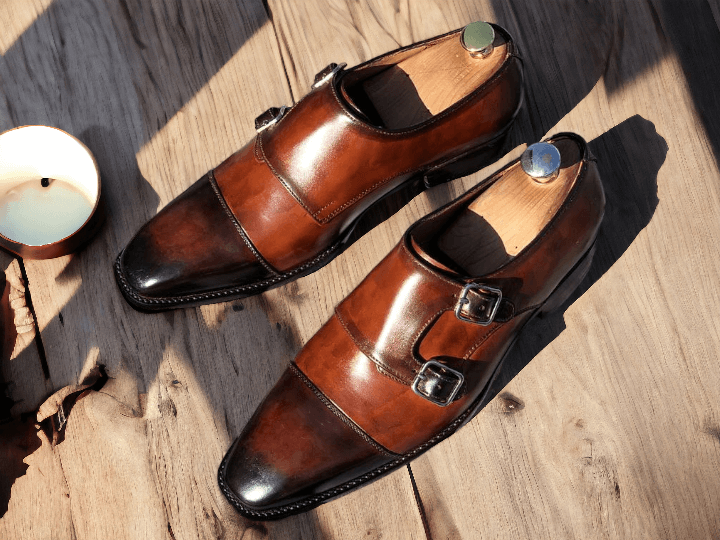 These Men's Handmade Burgundy Double Monk Buckle Strap Shoes feature a stylish burgundy hue and a handmade design for a unique and sophisticated look. The double monk buckle strap adds a touch of elegance and ensures a secure fit. Elevate your style with these high-quality, handcrafted shoes.