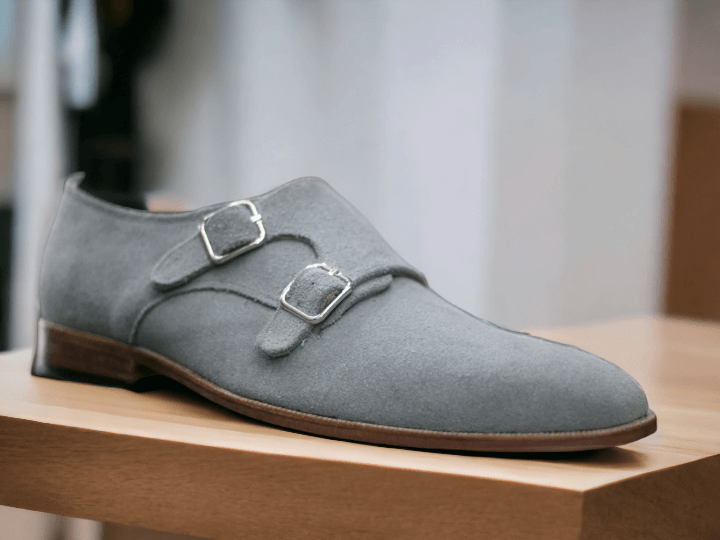 Made for the sophisticated man, our Bespoke Grey Suede Double Buckle Shoes offer both style and quality. Handcrafted with premium suede and featuring a plain toe design, these shoes will elevate any outfit. Experience the perfect fit with our tailored options and enjoy the timeless elegance of bespoke footwear.