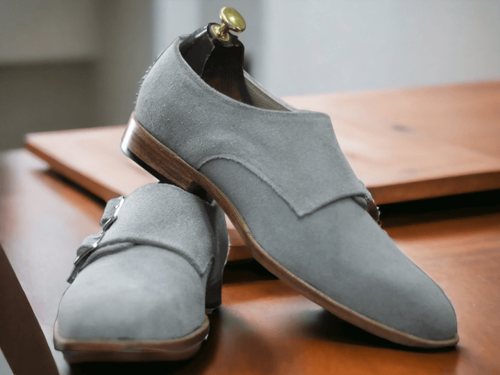 Made for the sophisticated man, our Bespoke Grey Suede Double Buckle Shoes offer both style and quality. Handcrafted with premium suede and featuring a plain toe design, these shoes will elevate any outfit. Experience the perfect fit with our tailored options and enjoy the timeless elegance of bespoke footwear.