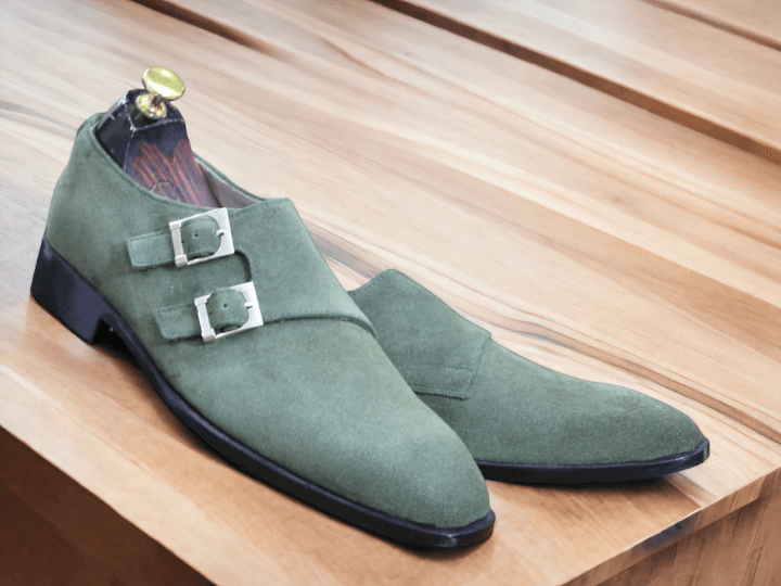 Expertly crafted and stylish, our Bespoke Men's Olive Green Monk Seede Shoes feature a double buckle design and a plain toe for a sophisticated look. Made from high-quality suede, these shoes offer comfort and durability while making a statement. Elevate your wardrobe with these timeless shoes.