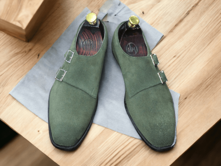 Expertly crafted and stylish, our Bespoke Men's Olive Green Monk Seede Shoes feature a double buckle design and a plain toe for a sophisticated look. Made from high-quality suede, these shoes offer comfort and durability while making a statement. Elevate your wardrobe with these timeless shoes.