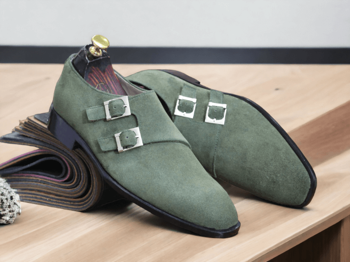 Expertly crafted and stylish, our Bespoke Men's Olive Green Monk Seede Shoes feature a double buckle design and a plain toe for a sophisticated look. Made from high-quality suede, these shoes offer comfort and durability while making a statement. Elevate your wardrobe with these timeless shoes.