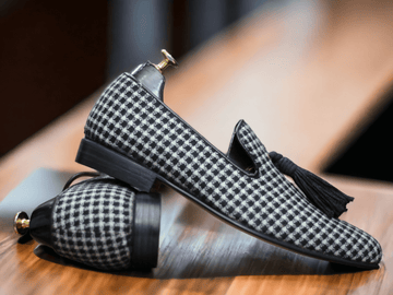 Crafted with expert precision, these handmade black and white leather shoes feature a unique dog tooth print design. Designed for men, these stylish loafer tussle shoes are the perfect blend of fashion and functionality. Elevate your style with these one-of-a-kind shoes.