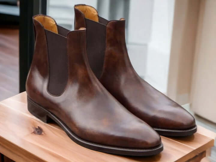 This men's leather boot is a true work of art, meticulously handcrafted using the finest tan Chelsea leather. The result is a luxurious and stylish choice that adds a touch of sophistication to your wardrobe. With its high ankle height, it's not only fashionable but also built for extra durability, making it a must-have addition for anyone with an eye for style.   