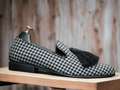 Crafted with expert precision, these handmade black and white leather shoes feature a unique dog tooth print design. Designed for men, these stylish loafer tussle shoes are the perfect blend of fashion and functionality. Elevate your style with these one-of-a-kind shoes.