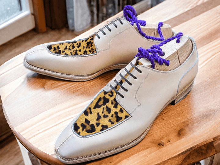 Expertly crafted by hand, our Men's White Leopard Designer Shoes showcase sophistication and style. The unique leopard print design adds a touch of boldness, while the high-quality materials ensure durability and comfort for the wearer. Make a statement with these luxurious, handmade shoes.