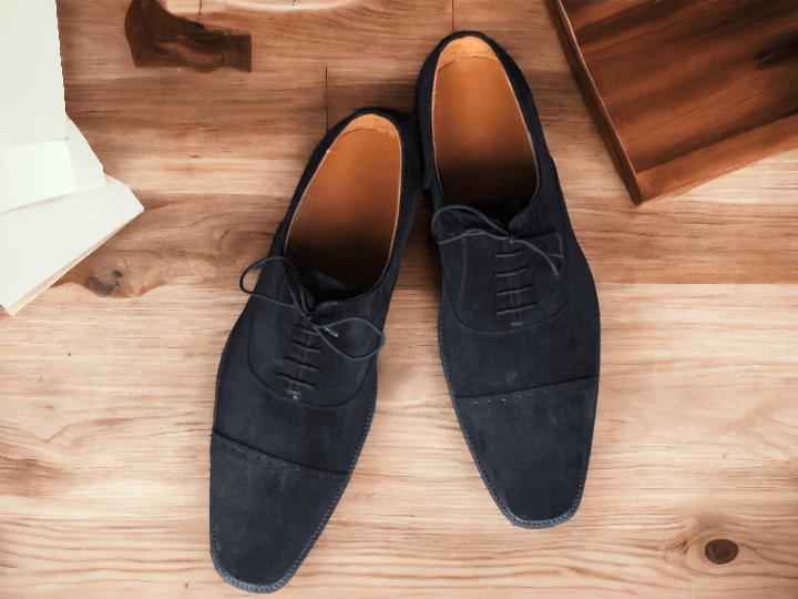 Expertly crafted with a black cap toe and suede material, these handmade lace up shoes are the epitome of formal elegance and style. With their superior quality and timeless design, they are perfect for any formal occasion and add sophistication to any outfit. Indulge in luxury and comfort with these men's dress shoes.