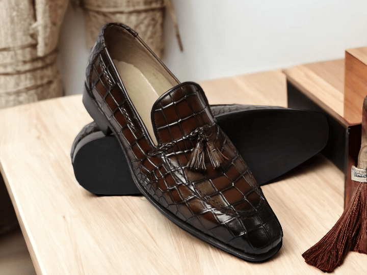 Indulge in luxury with our Handmade Men's Brown Alligator Print Shoes. These slip-on loafers with tussle detailing are meticulously crafted for a premium fit and style. Elevate your wardrobe and make a statement with these exclusive, handmade shoes.