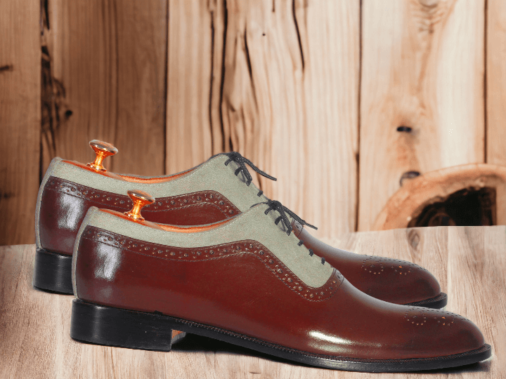 Expertly crafted from premium gray suede and accented with burgundy leather, these handmade wing tip brogue shoes are the epitome of luxury and style. A must-have for any stylish man, these designer shoes offer unmatched quality and sophistication. Elevate your wardrobe with these unique and timeless shoes.