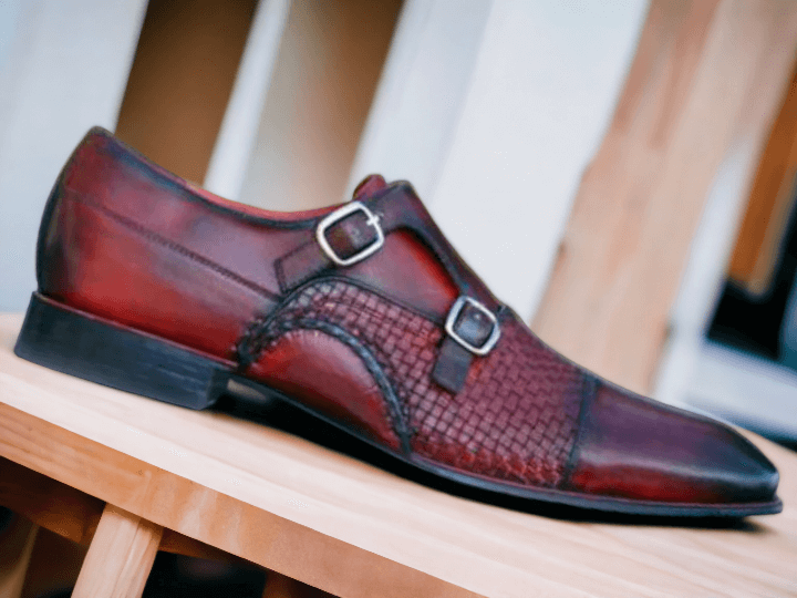 Expertly handcrafted from premium leather, these Double Monk Woven Burgundy Shoes add a touch of sophistication to any outfit. The intricate weaving detail and double monk strap design elevate the classic shoe, making it a versatile piece for any occasion. Step out in style with these high-quality, handmade shoes.