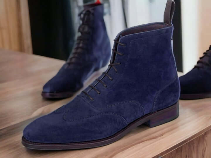 Expertly crafted and designed for the modern man, these handmade navy suede ankle boots are the perfect fusion of style and functionality. Made from high-quality leather and suede, these ankle high boots offer both classic and fashion-forward elements. Elevate your look and step out confidently in these versatile and stylish boots.