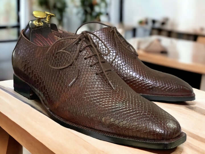 Elevate your look with this men's handmade designer shoe. Crafted from premium leather with a Python print wholecut design, these shoes exude sophistication and style. Perfect for formal business occasions, this shoe will add a touch of class to any wardrobe.