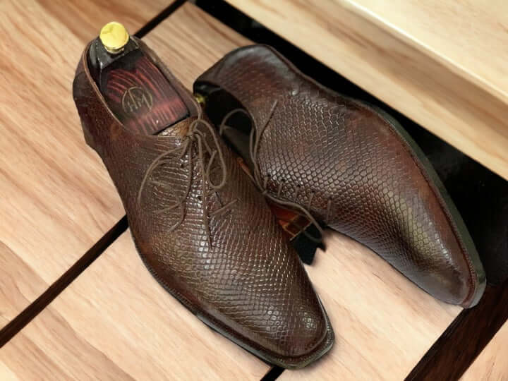 Elevate your look with this men's handmade designer shoe. Crafted from premium leather with a Python print wholecut design, these shoes exude sophistication and style. Perfect for formal business occasions, this shoe will add a touch of class to any wardrobe.