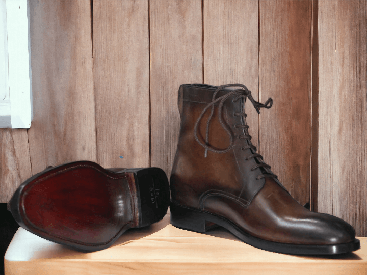 This men's boot is crafted with vintage leather and hand-painted for a unique design. It features a classic lace-up style with a sturdy rubber sole for a durable wear. Perfect for a timeless, stylish look.