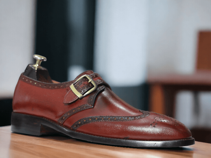 Step up your office wear game with our Men's Handmade Burgundy Monk Strap Shoes. Expertly crafted with a stylish buckle, these shoes exude professionalism and sophistication. Elevate your style and make a statement in the workplace.