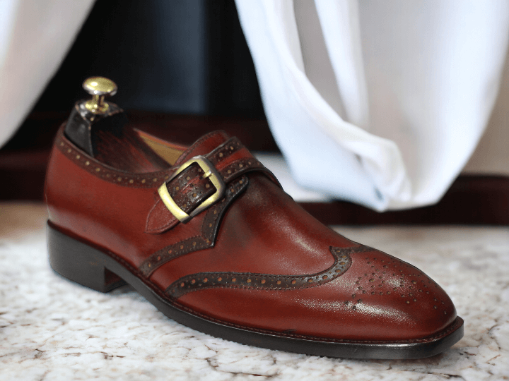 Step up your office wear game with our Men's Handmade Burgundy Monk Strap Shoes. Expertly crafted with a stylish buckle, these shoes exude professionalism and sophistication. Elevate your style and make a statement in the workplace.