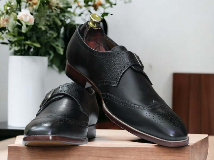 These men's black monk strap shoes are handcrafted with stylish single straps, perfect for office wear. Their classic design and high-quality leather make them a comfortable and fashionable choice. Upgrade your business attire with these functional and sleek buckle shoes.