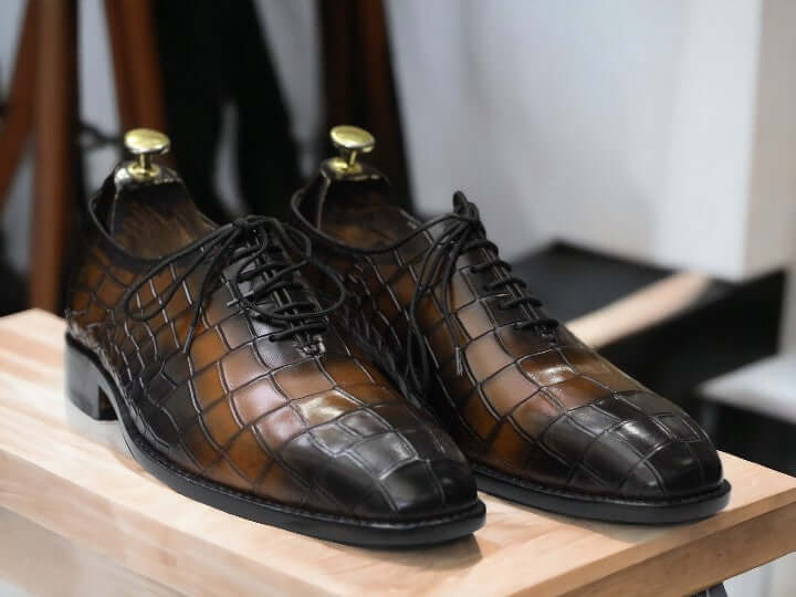 Expertly crafted for durability, these handmade Oxfords showcase a unique alligator print, adding a touch of sophistication to any outfit. Perfect for the stylish and practical man, these shoes are built to last and elevate your wardrobe.