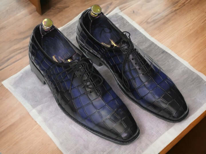 Expertly crafted for durability, these handmade Oxfords showcase a unique alligator print, adding a touch of sophistication to any outfit. Perfect for the stylish and practical man, these shoes are built to last and elevate your wardrobe.