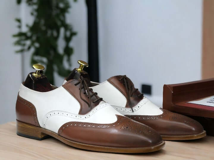 Expertly crafted, these Men Wingtip Oxford Shoes feature handmade brown and black leather for a sophisticated and timeless look. The wingtip design adds a touch of elegance, making these shoes perfect for any formal or professional event. Expertly crafted for lasting durability and style.