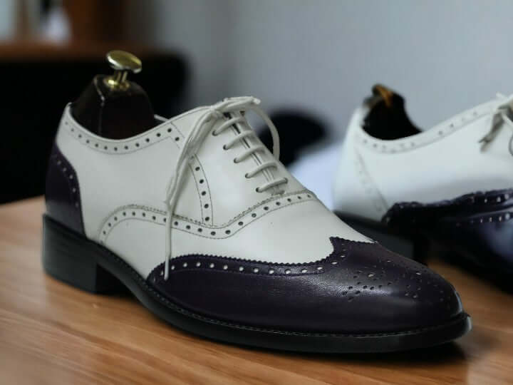 Step out in style with these Men's Purple White Oxfords - a perfect blend of elegance and sophistication. Featuring a classic wing tip brogue design and crafted from genuine leather, these shoes exude both style and superior quality, elevating your formal ensemble effortlessly.