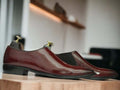 These Men's Maroon Patent Chelsea Shoes are handcrafted from high-quality leather, providing a polished and sophisticated look suitable for any dressy occasion. Featuring the classic Chelsea style with a sleek patent finish, these shoes are sure to elevate any outfit. Perfect for any fashion-forward man looking to make a statement.