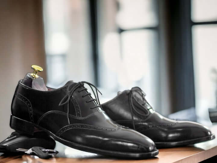 These timeless handmade men's black wingtip oxford shoes feature classic detailing for a sophisticated look. Crafted with superior quality leather, they are finished with a durable rubber sole for long-lasting wear. Perfect for formal or business events.