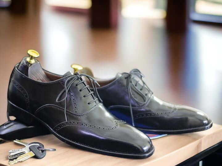 These timeless handmade men's black wingtip oxford shoes feature classic detailing for a sophisticated look. Crafted with superior quality leather, they are finished with a durable rubber sole for long-lasting wear. Perfect for formal or business events.