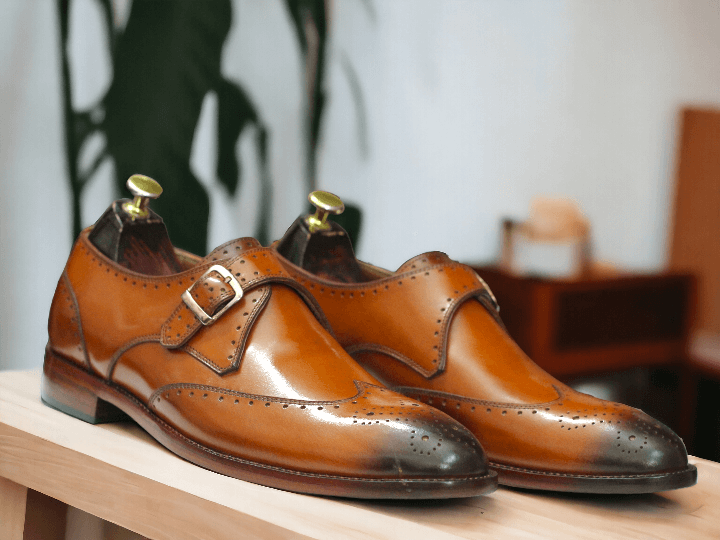 These Men Tan Monk Buckle Leather Shoes are the perfect combination of style and comfort. With a sleek lace-up design and monk buckle detail, these dress leather shoes are perfect for any formal occasion. Made from high-quality leather, they provide both durability and sophistication. Elevate your shoe game with these must-have shoes.