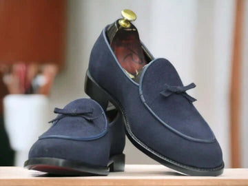 These men's navy blue leather suede loafers are the perfect addition to any man's shoe collection. With a slip-on design, they provide easy and comfortable wear for any casual occasion. The high-quality materials and stylish design make these shoes a must-have for any fashion-forward man.