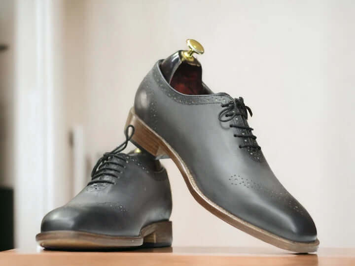 Elevate your style with our Men Handmade Grey Whole cut Oxfords Shoes. These Two Tone Oxfords are crafted with precision and attention to detail, ensuring a perfect fit and comfort for your feet. Handmade with top-quality materials, they exude sophistication and offer a timeless addition to your wardrobe.