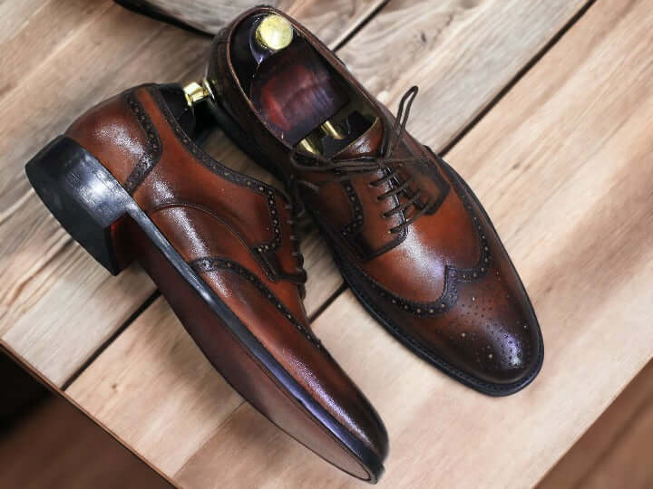 This sophisticated pair of Brown Wingtip Oxford Brogue Shoes exudes classic style and timeless elegance. Crafted from premium leather, these shoes will look sharp with any formal or casual ensemble. A perfect blend of traditional style with modern comfort.