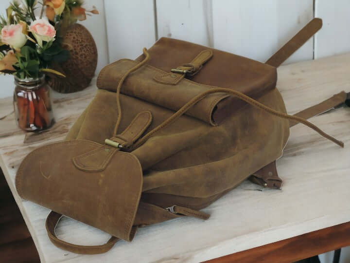 Expertly crafted from genuine leather, this handmade backpack is perfect for college students. The backpack features a front pocket for easy access to essentials, making it a practical and stylish choice for everyday use. Stay organized and look sophisticated with the Country Leather Backpack.