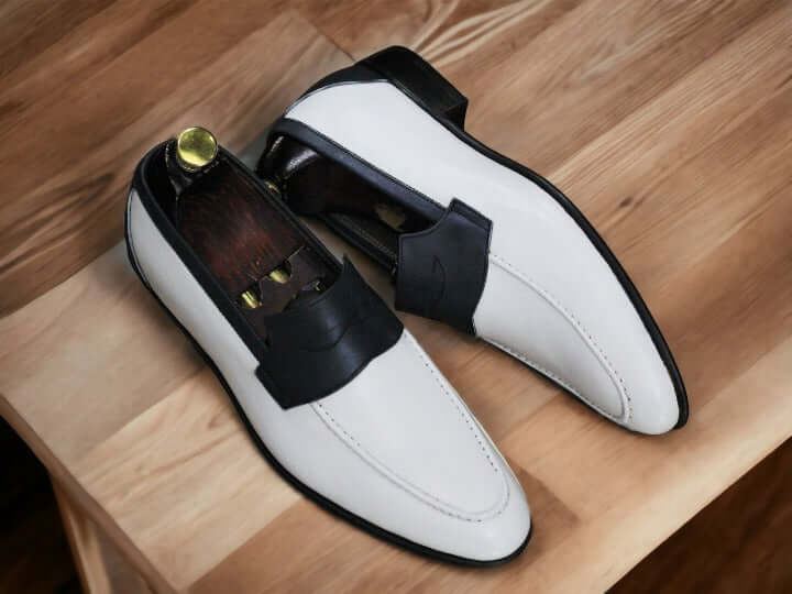 These White Black Loafer Shoes feature a premium combination of white leather and black suede with an elegant, timeless design. The well-crafted, combination leather and suede upper offers unparalleled comfort and support, while the memory foam insole provides superior cushioning for all-day wear.