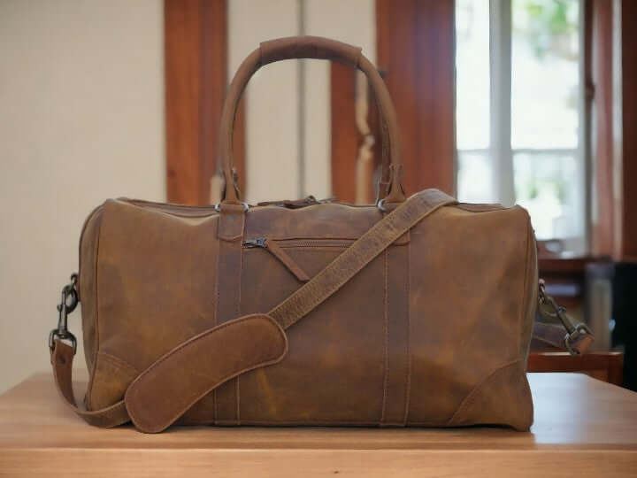 Introducing our Leather Sports Duffle, the perfect companion for your travels and workouts. Handcrafted from durable leather, this weekender bag doubles as a gym bag, vacation duffel, and overnight bag. With its sleek design and spacious interior, it's a must-have for any adventurer. Treat your loved one to the ultimate Valentine's Day gift.