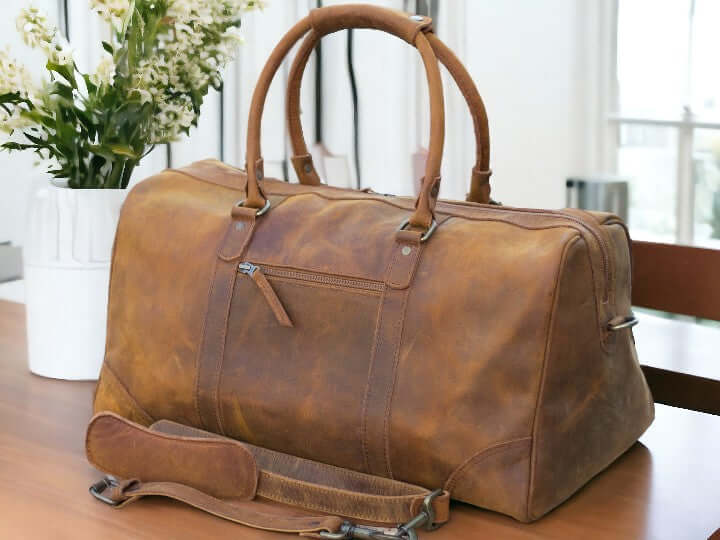 Introducing our Leather Sports Duffle, the perfect companion for your travels and workouts. Handcrafted from durable leather, this weekender bag doubles as a gym bag, vacation duffel, and overnight bag. With its sleek design and spacious interior, it's a must-have for any adventurer. Treat your loved one to the ultimate Valentine's Day gift.