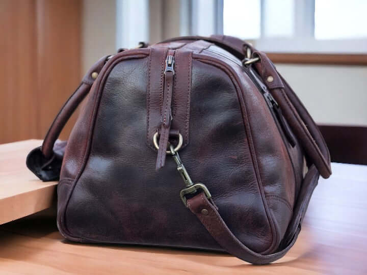 This full grain leather duffel bag is perfect for your next weekend getaway or vacation. Handmade with the highest quality leather, it offers durability and style. Its spacious design and sturdy construction make it the best gift for men and groomsmen. Upgrade your travel game with this luxurious weekender bag.