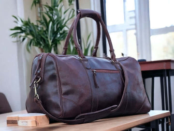 This full grain leather duffel bag is perfect for your next weekend getaway or vacation. Handmade with the highest quality leather, it offers durability and style. Its spacious design and sturdy construction make it the best gift for men and groomsmen. Upgrade your travel game with this luxurious weekender bag.